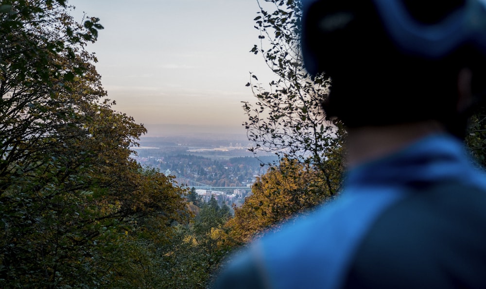 a man is looking out over a valley