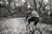 A focused cyclist receiving one-on-one coaching on a forest trail.