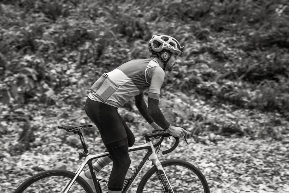 a man riding a bike down a dirt road