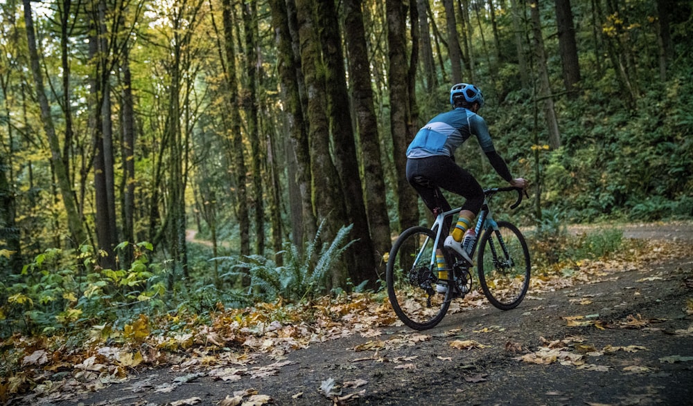 a man riding a bike down a dirt road