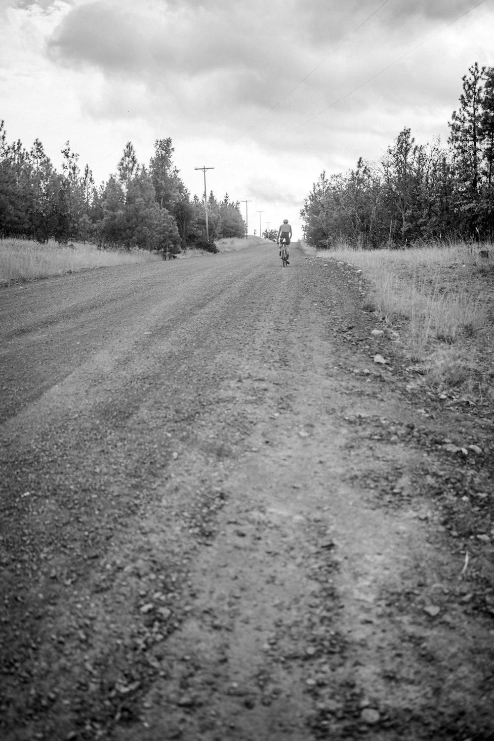 a person riding a bike down a dirt road