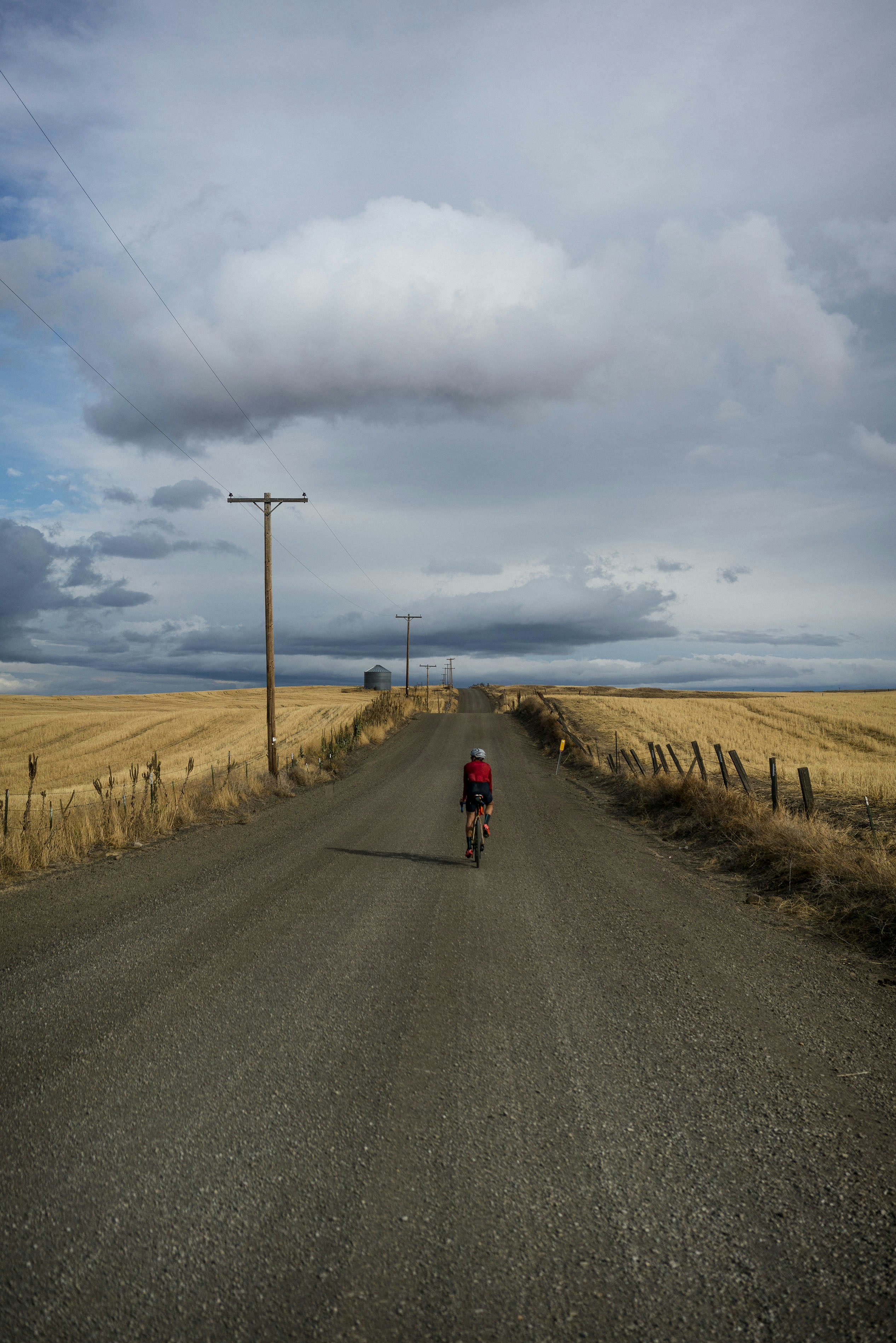 a person riding a bike down a dirt road