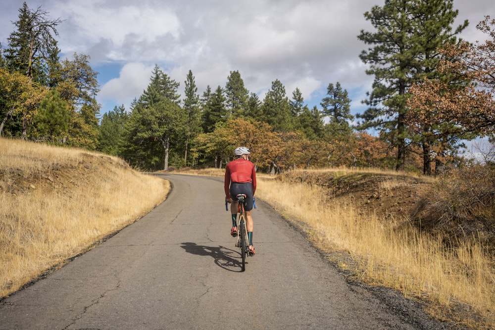 a man riding a bike down a rural road