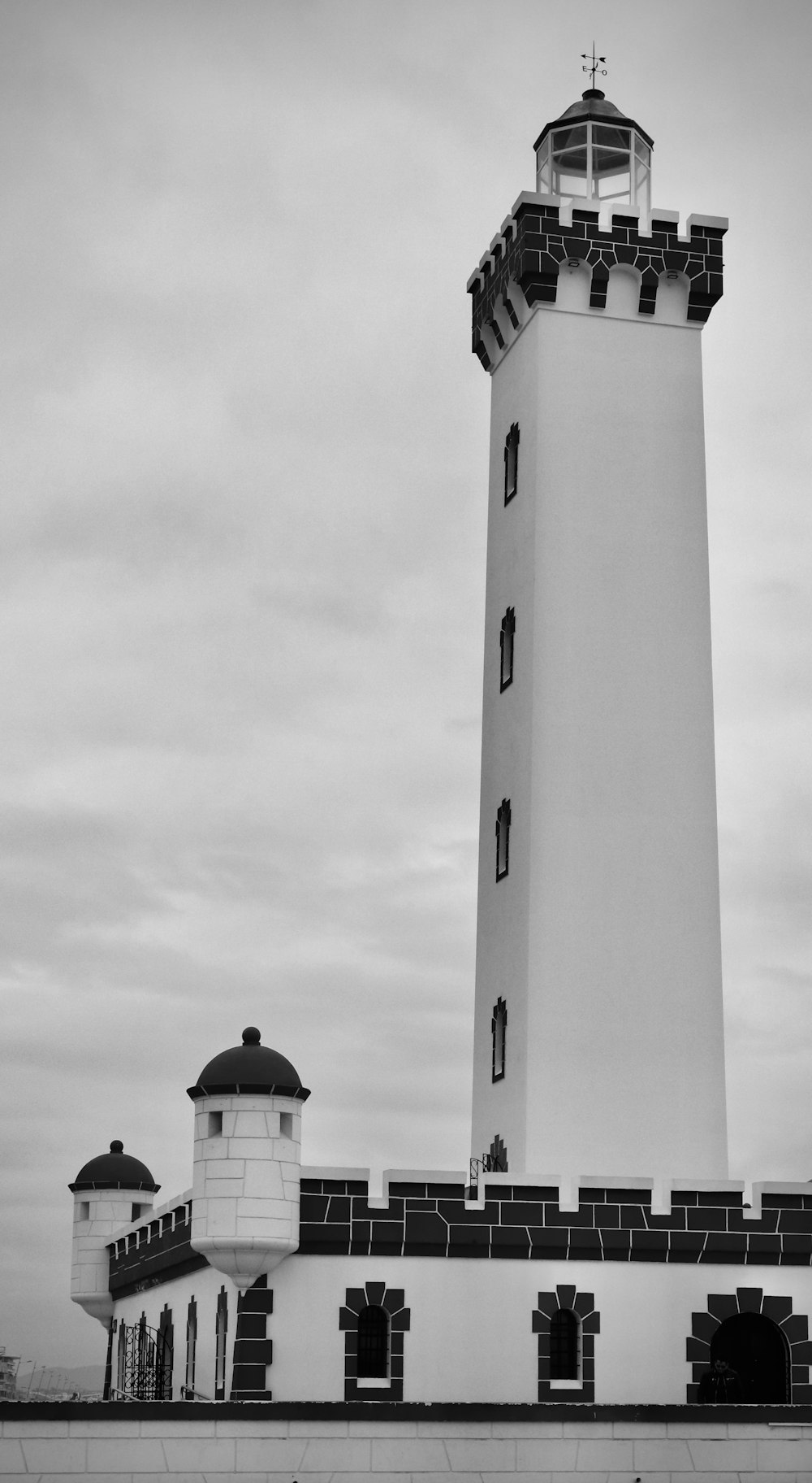 a black and white photo of a lighthouse