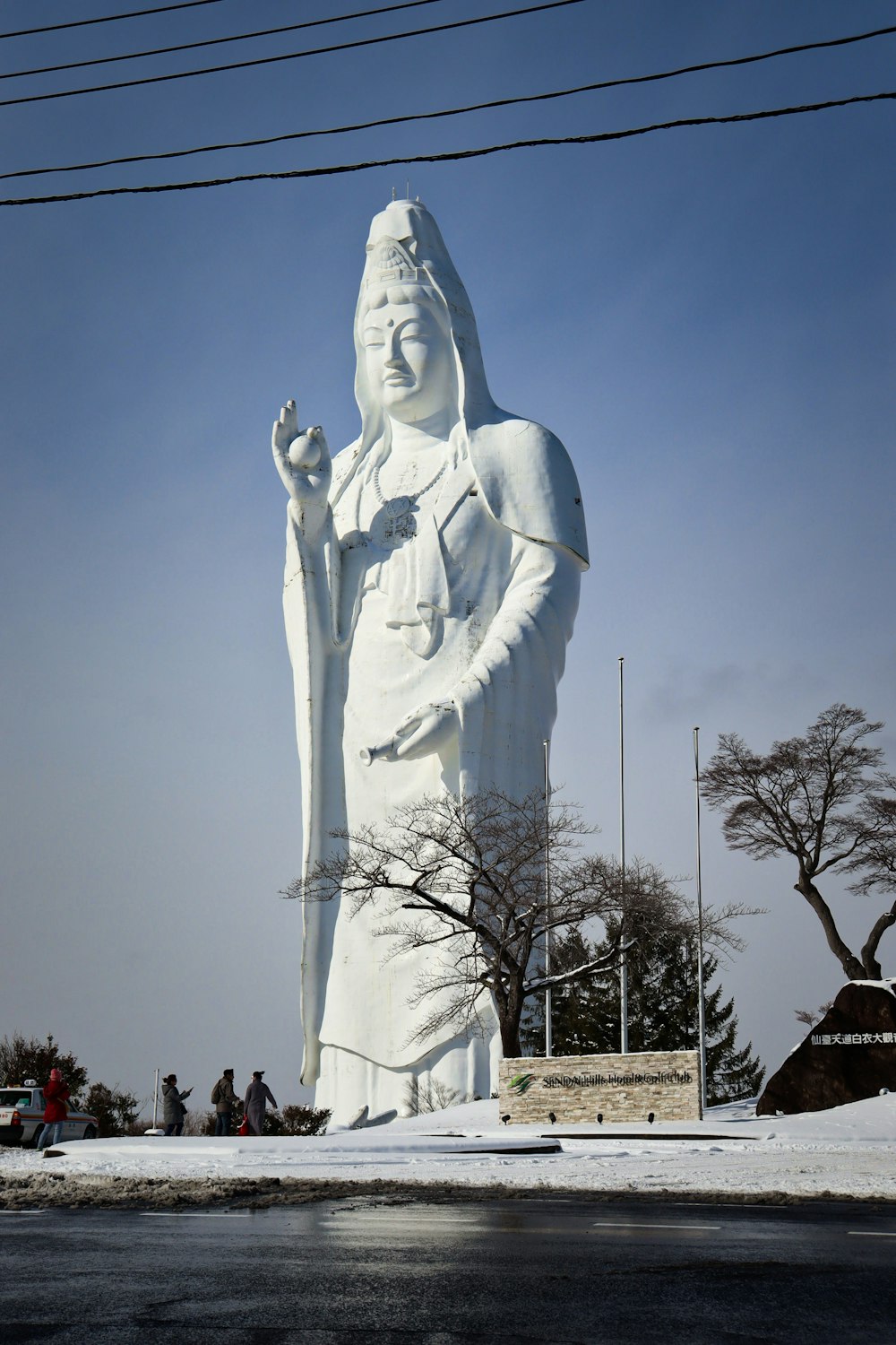 a large white statue of a woman holding a cane
