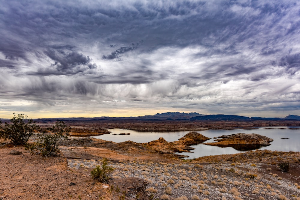 a large body of water surrounded by a desert landscape