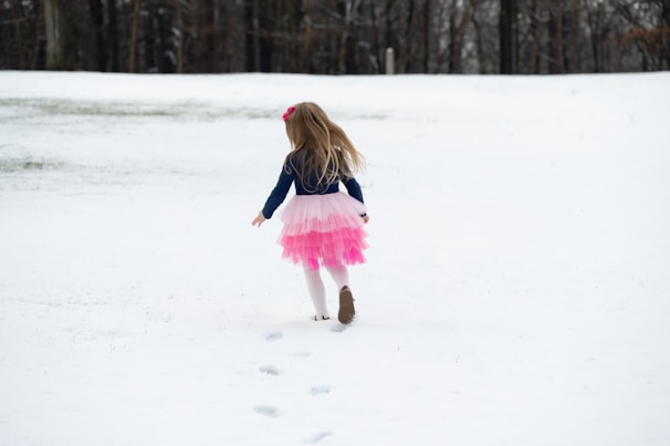 A young girl skiing on a snowy slope in France.