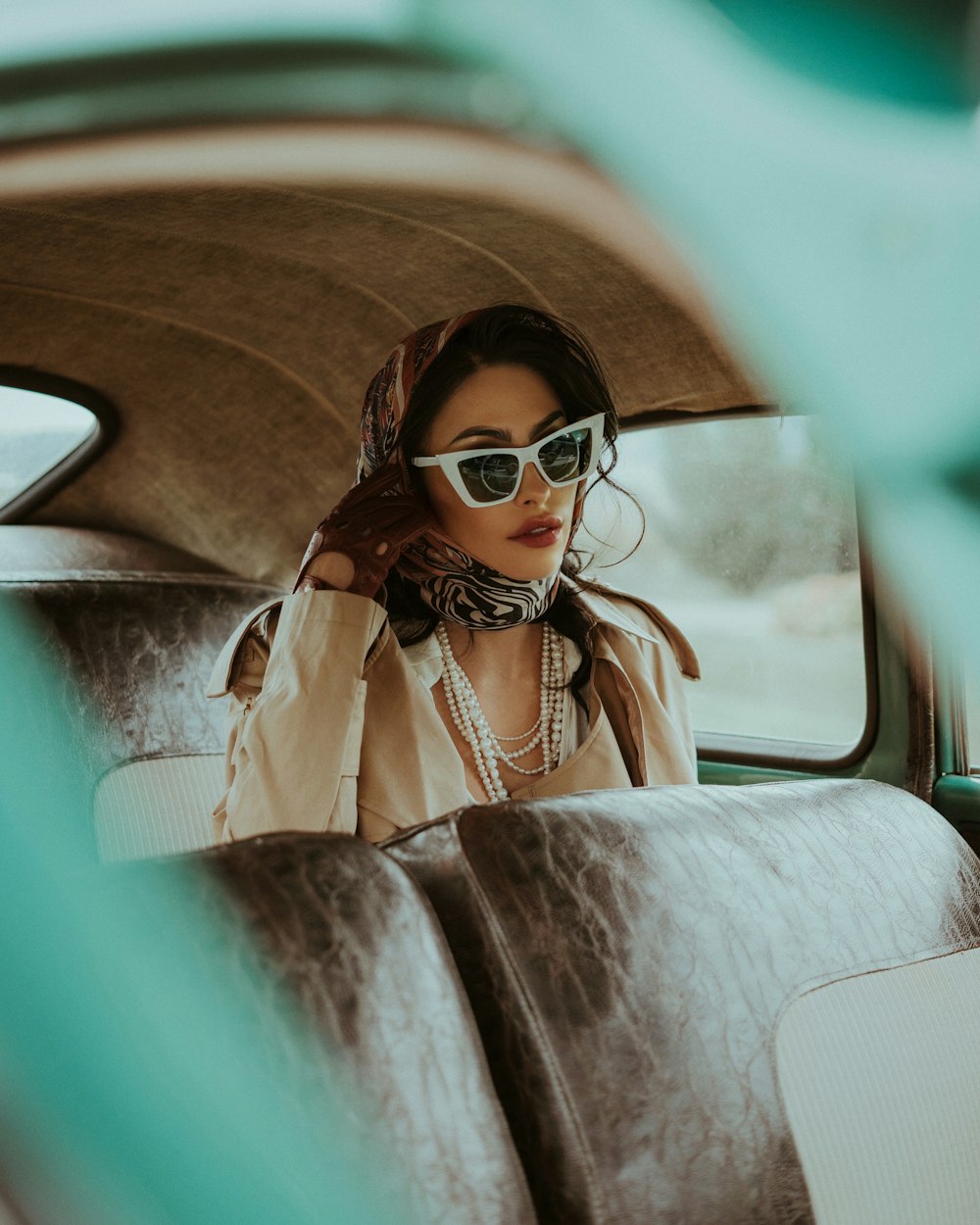 a woman sitting in the back seat of a car