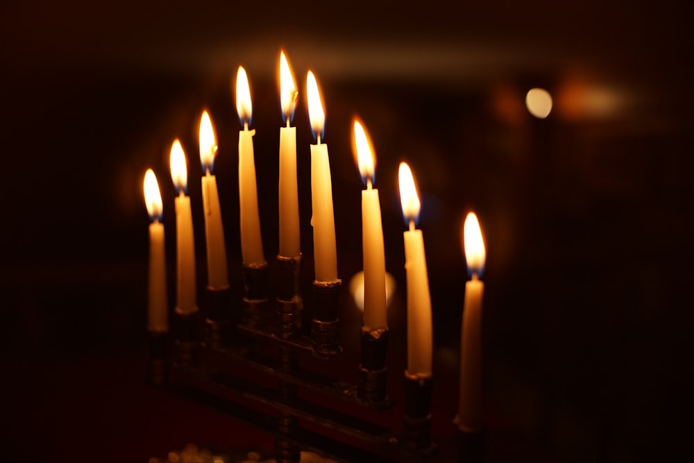 a group of lit candles in a dark room