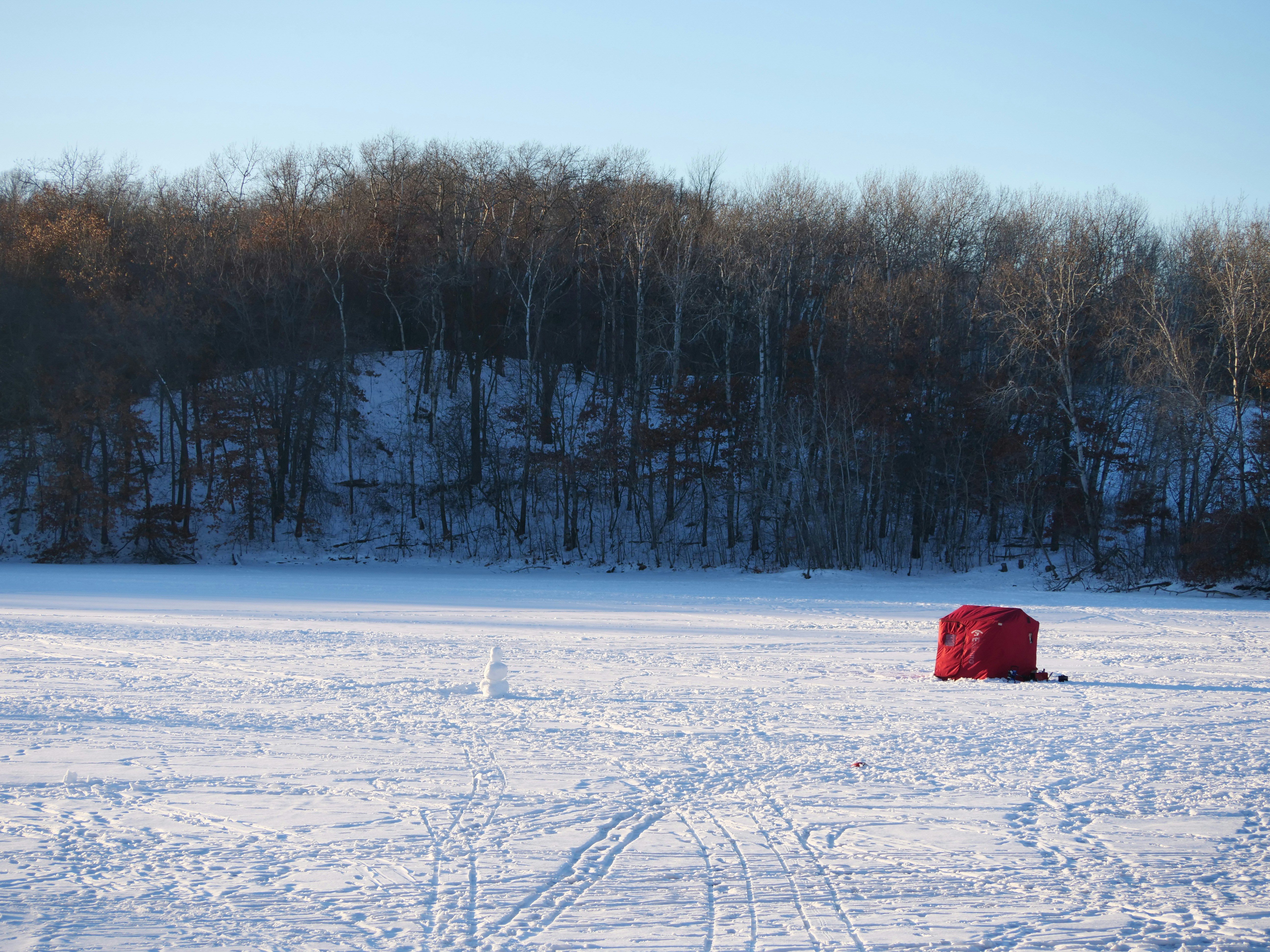 a red box sitting in the middle of a snow covered field