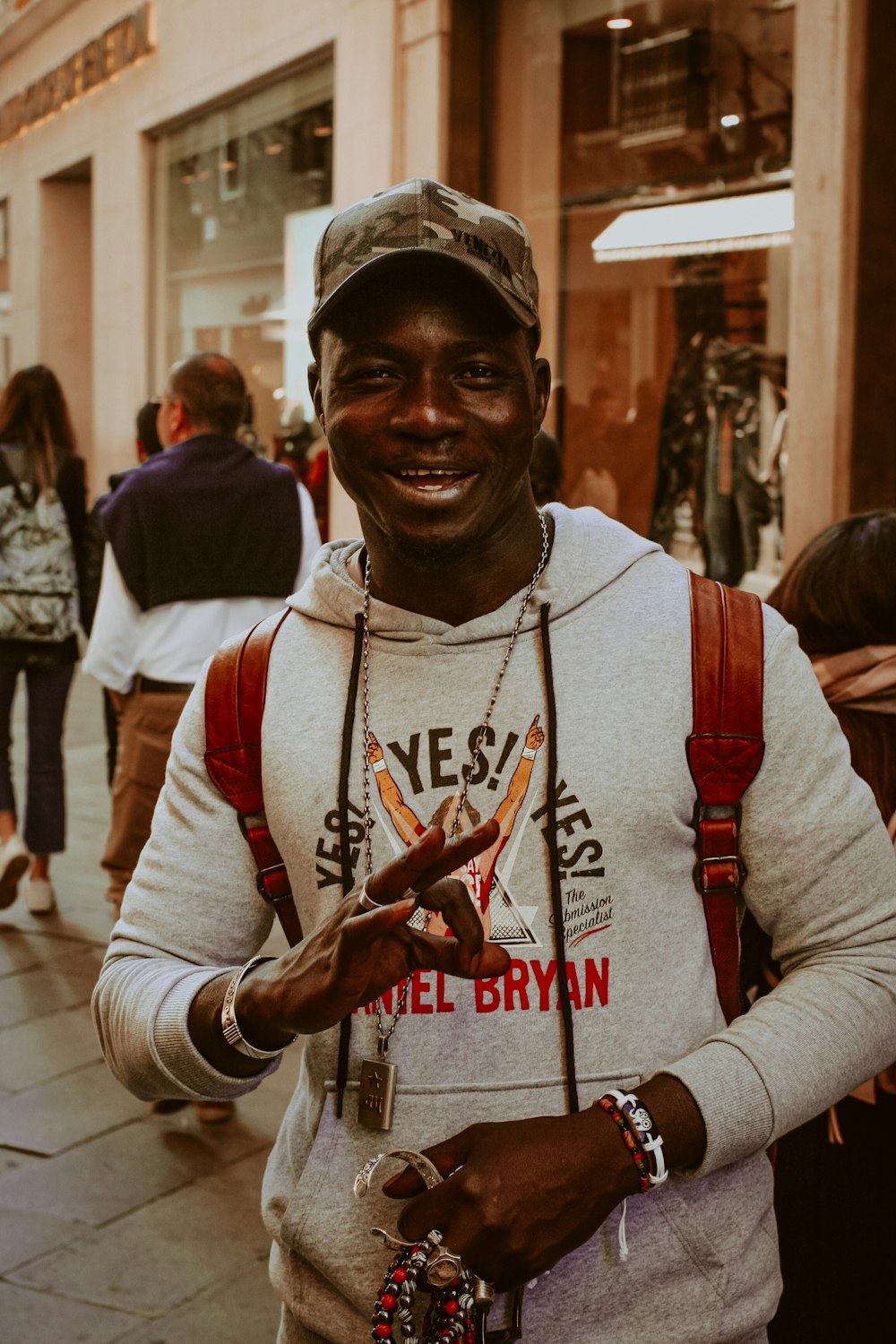 a man standing on a street with a smile on his face