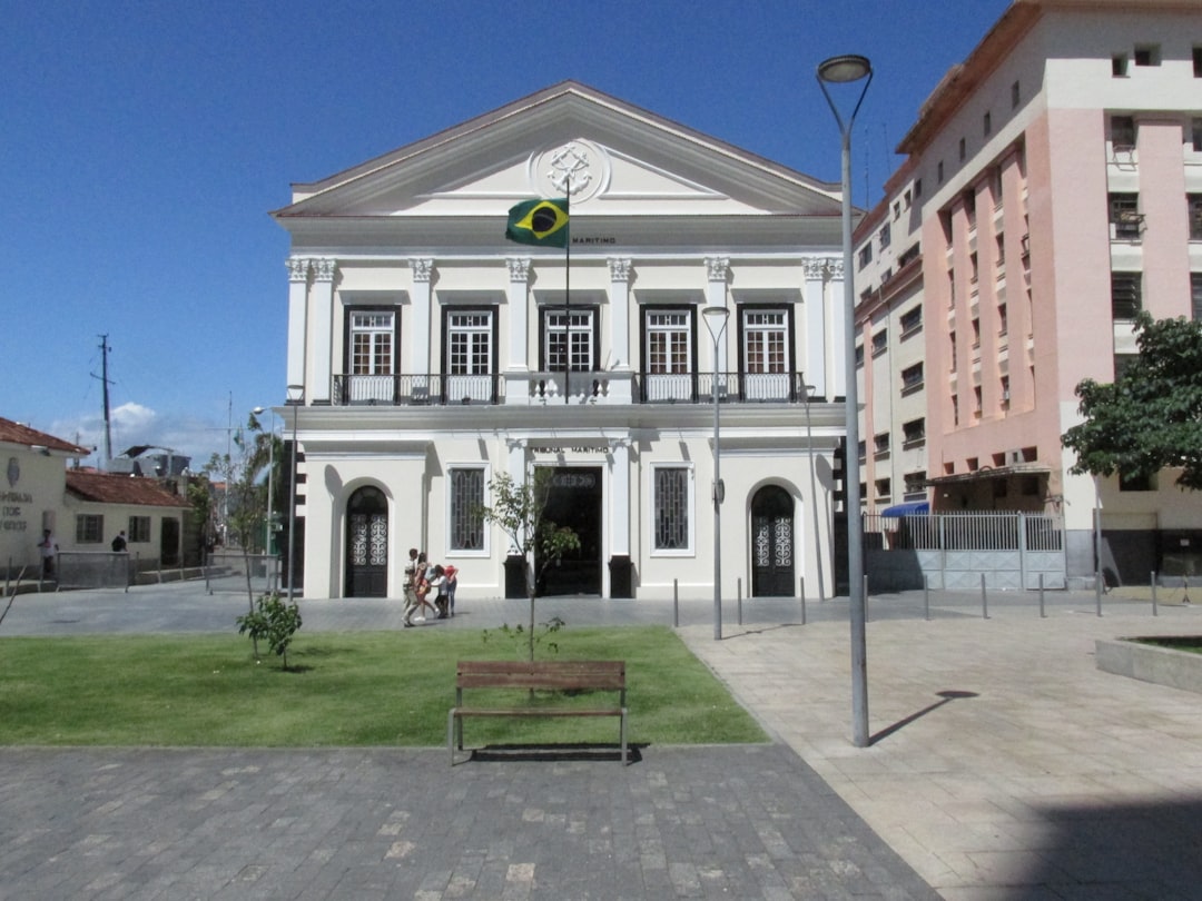 a bench in front of a building with a flag on it,