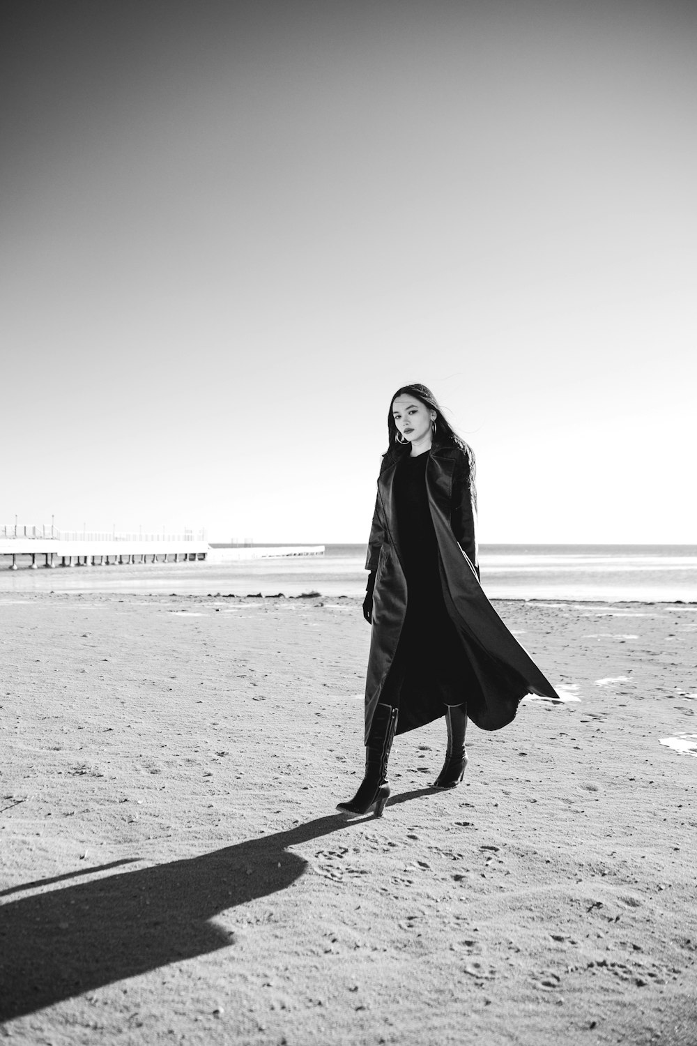 a woman standing on top of a sandy beach