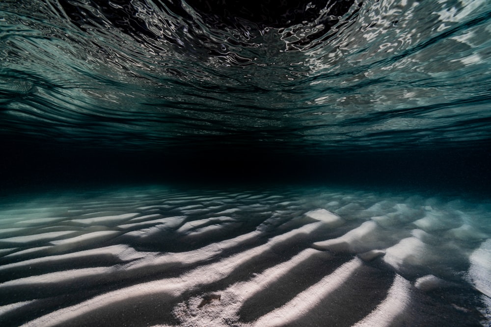 an underwater view of sand and water