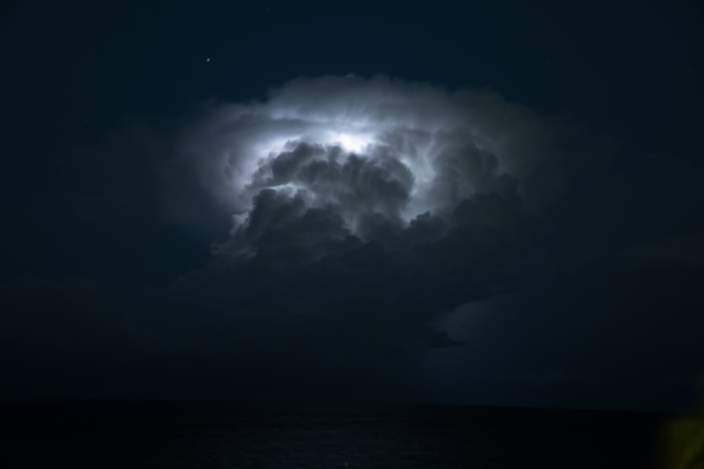a cloud with a lightning bolt in the sky