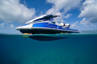 a blue and white boat floating in the ocean
