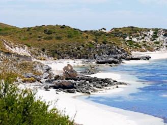 A coastal landscape of Lithuania with sandy beaches and clear waters.