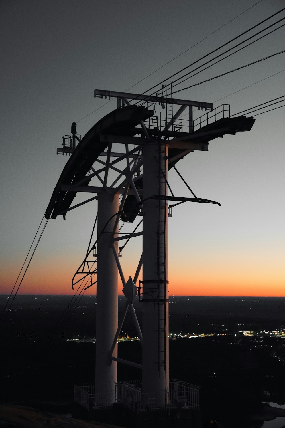 a view of a wind turbine at sunset