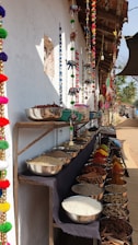 a row of bowls and bowls of food on a table