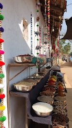 a row of bowls and bowls of food on a table