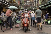 A busy street scene with people engaging in daily activities.