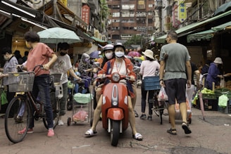 A busy street scene with people engaging in daily activities.