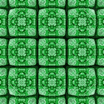 A series of intricate, symmetrical patterns resembling mandalas, each featuring a floral design. The patterns are organized in a grid formation and contain detailed motifs with various shades of green.