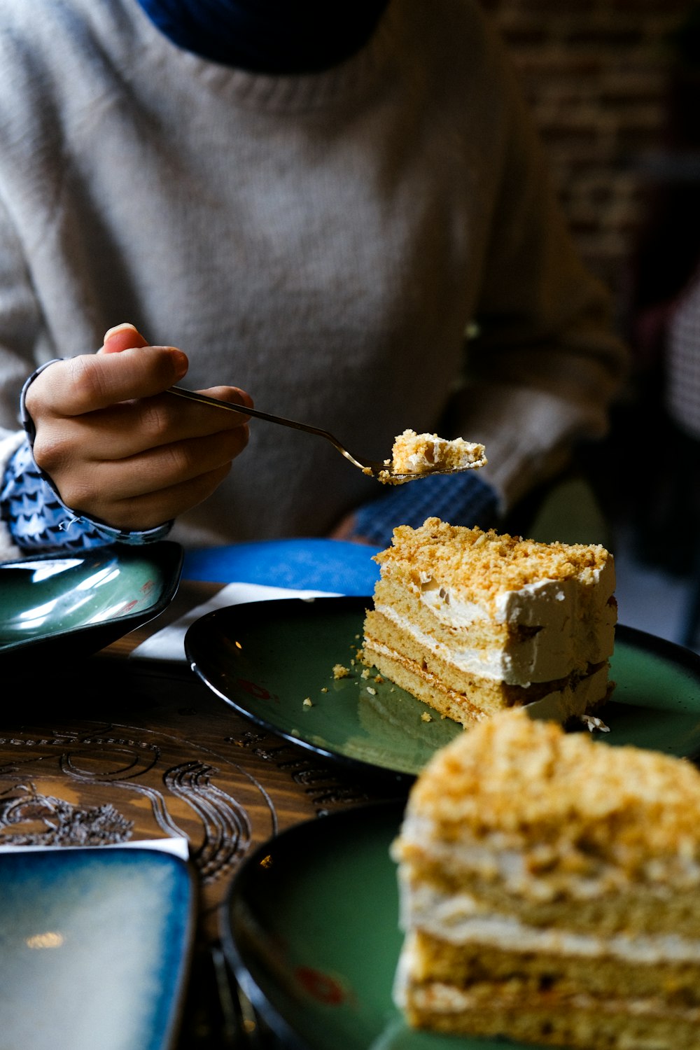 a person eating a piece of cake on a plate