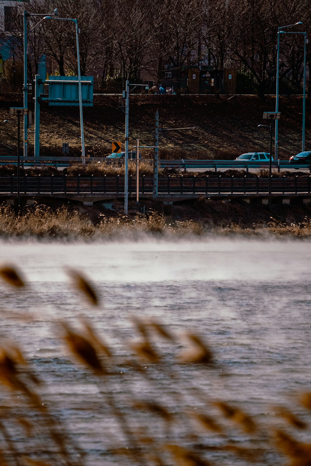 a body of water next to a train track