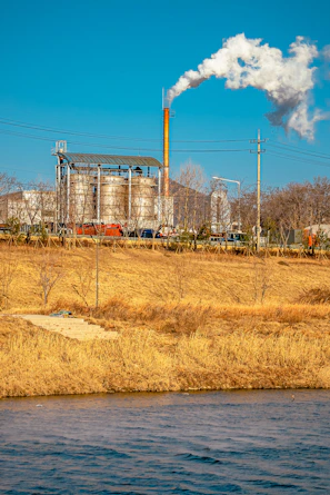 Industrial cement plant with smoke stacks using coffee pellet biofuel in the furnace.