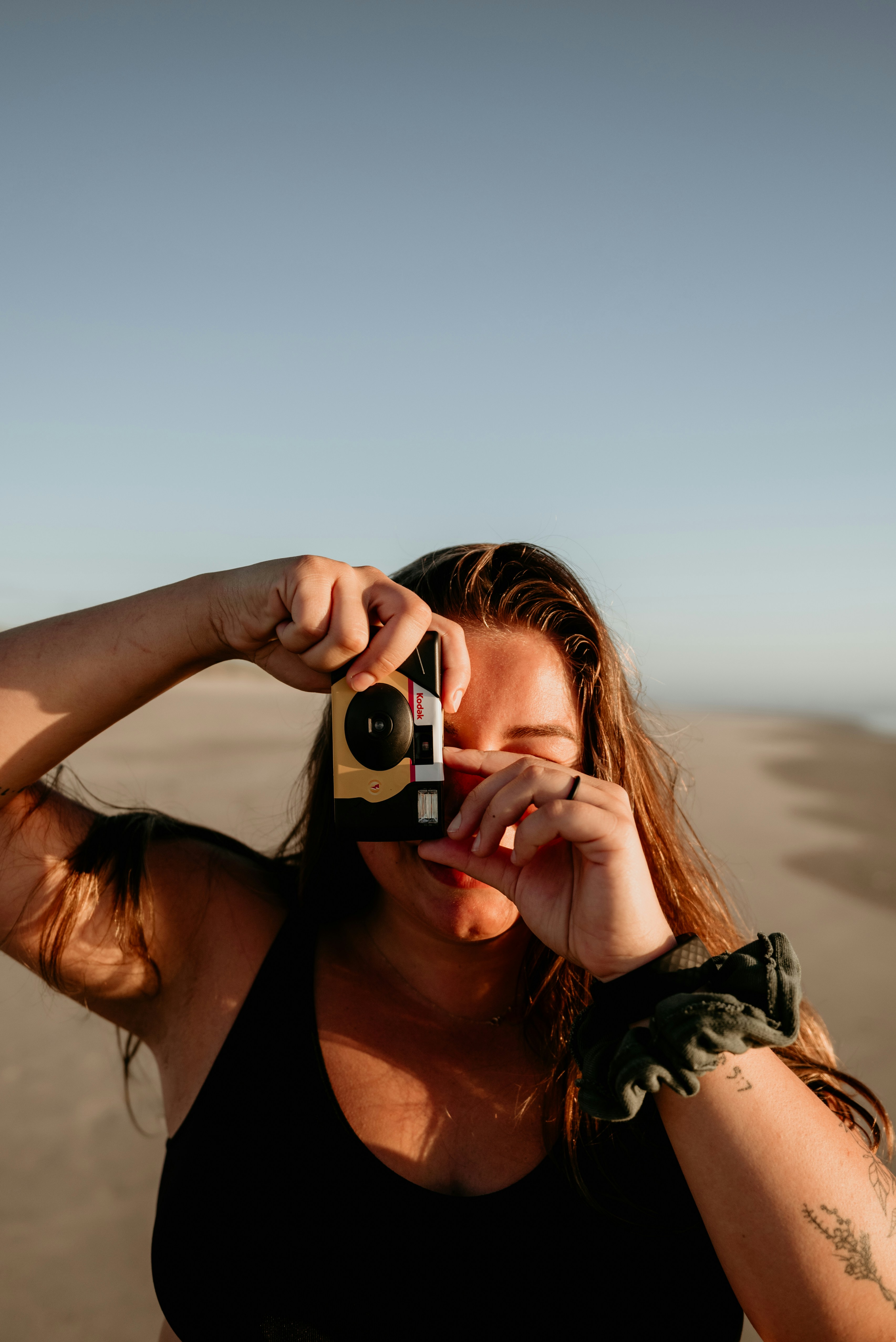 a woman taking a picture of herself with a camera