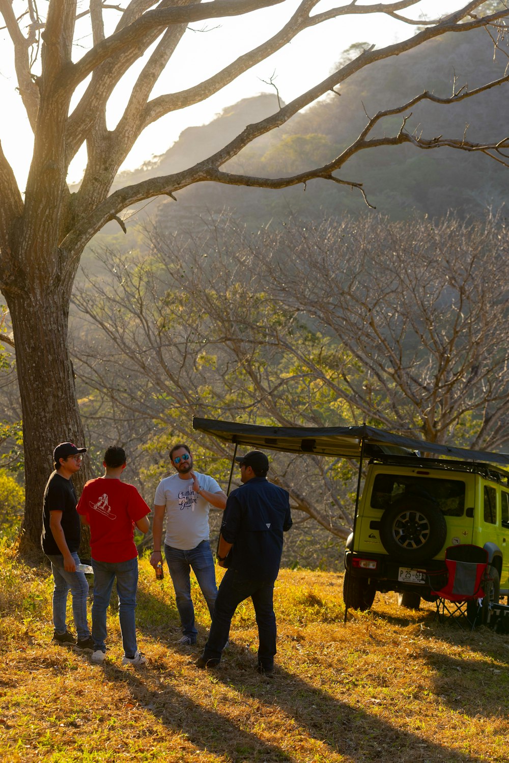 a group of people standing next to a tree