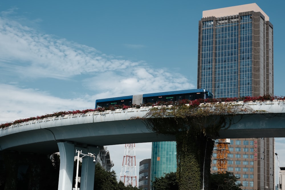 a blue and white train traveling over a bridge
