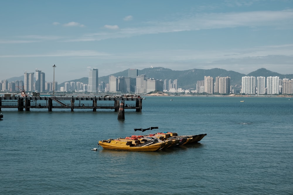 a yellow boat floating on top of a large body of water