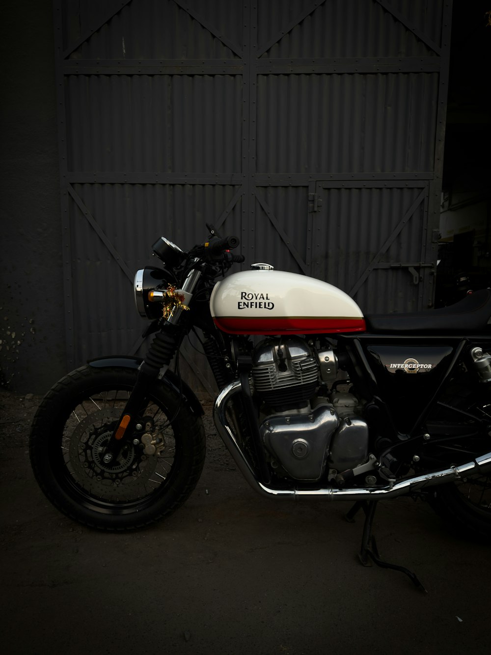 a white and red motorcycle parked in front of a building