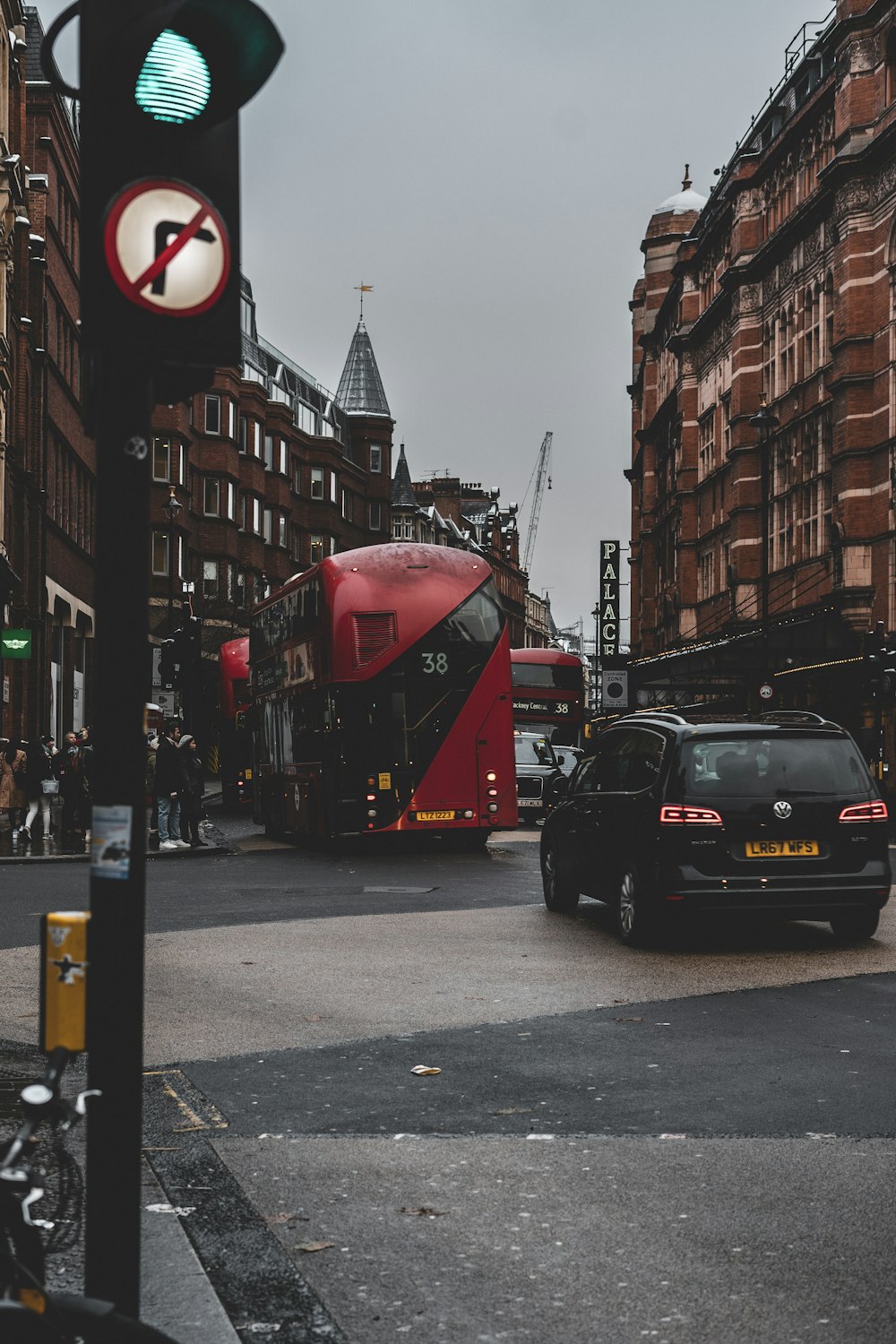 a red double decker bus on a city street