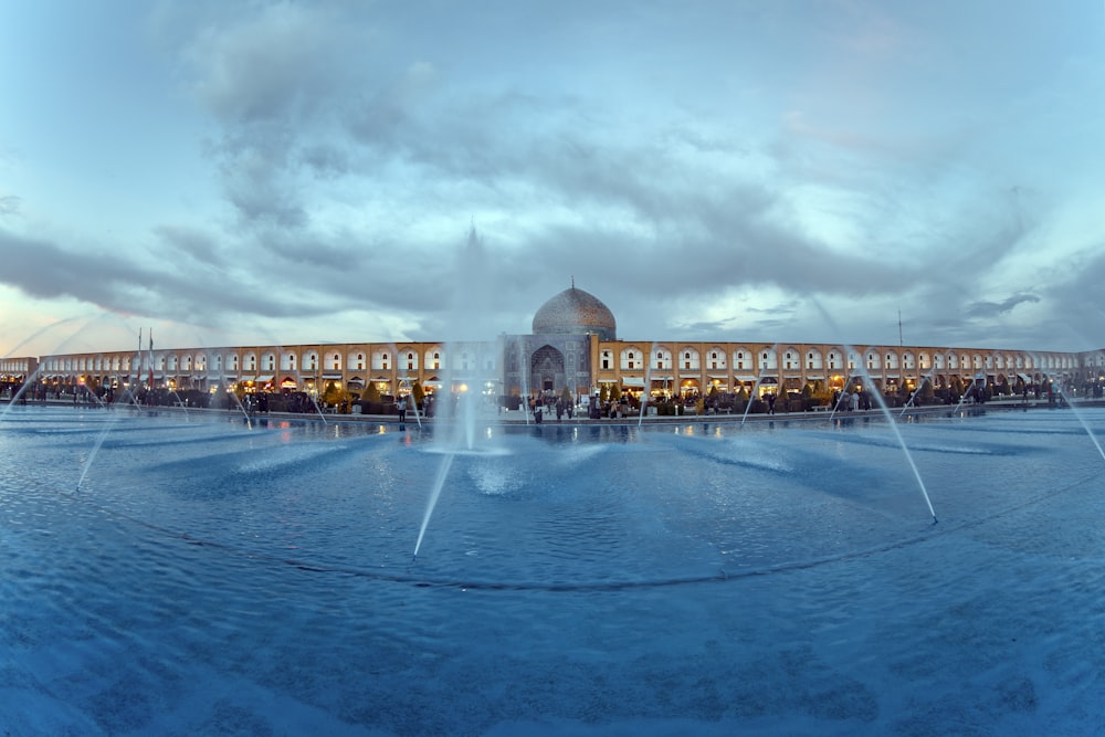 a large fountain in front of a large building