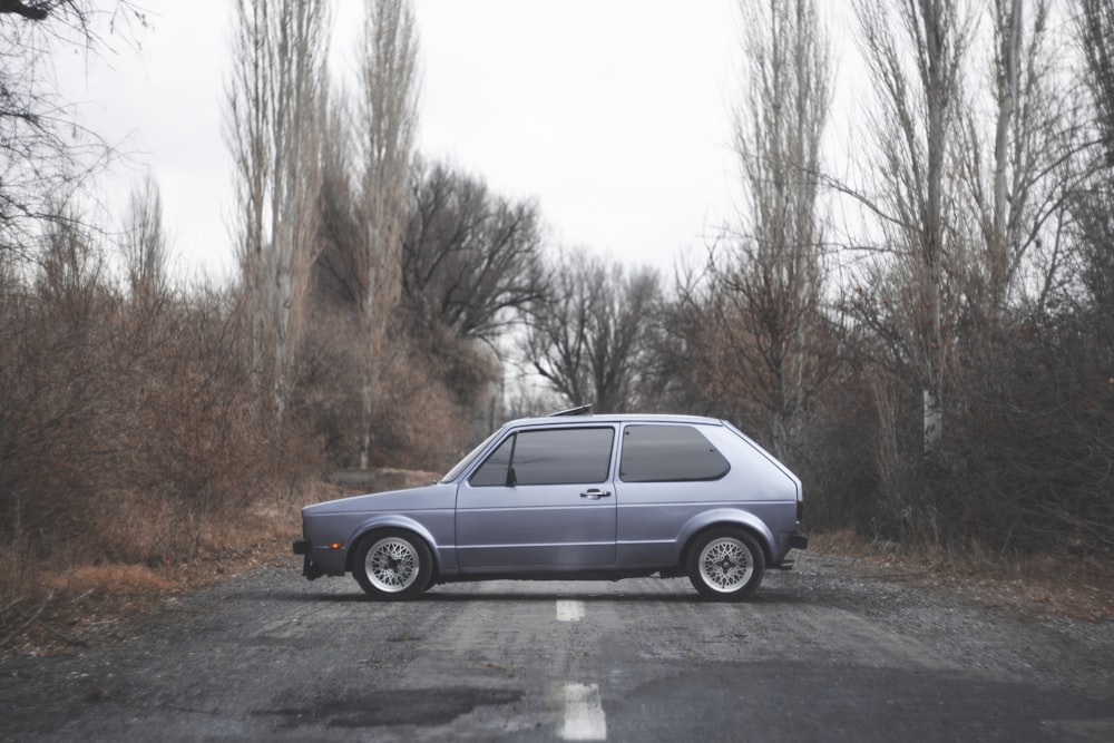 a small car parked on the side of a road