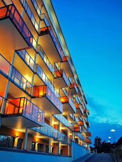 Modern apartment exterior with sleek lines and warm lighting at dusk