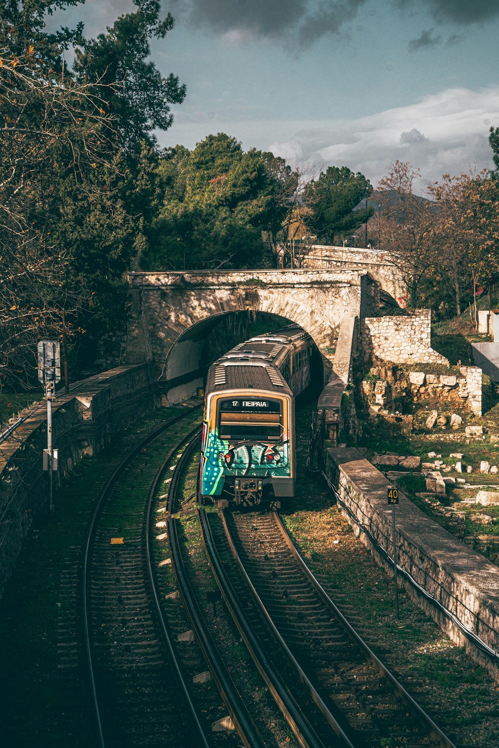 a train traveling through a tunnel under a bridge
