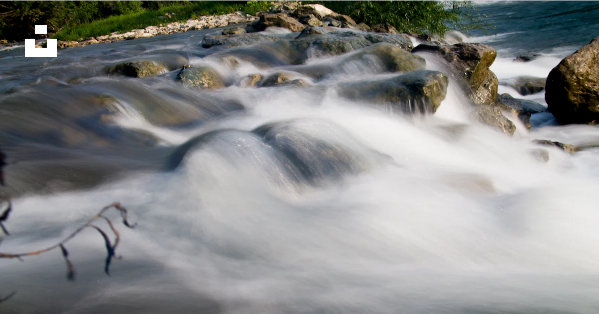 A stream of water running over rocks in a river photo – Free River ...