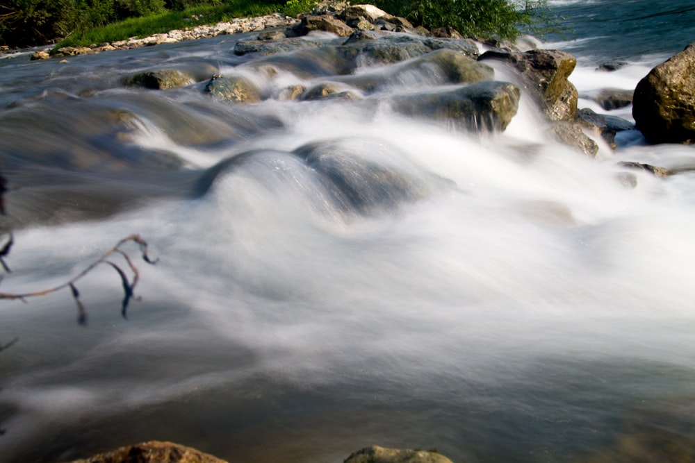 a stream of water running over rocks in a river