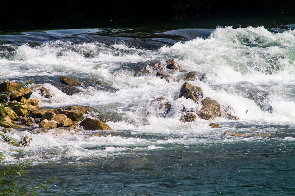 the water is rushing over the rocks in the river