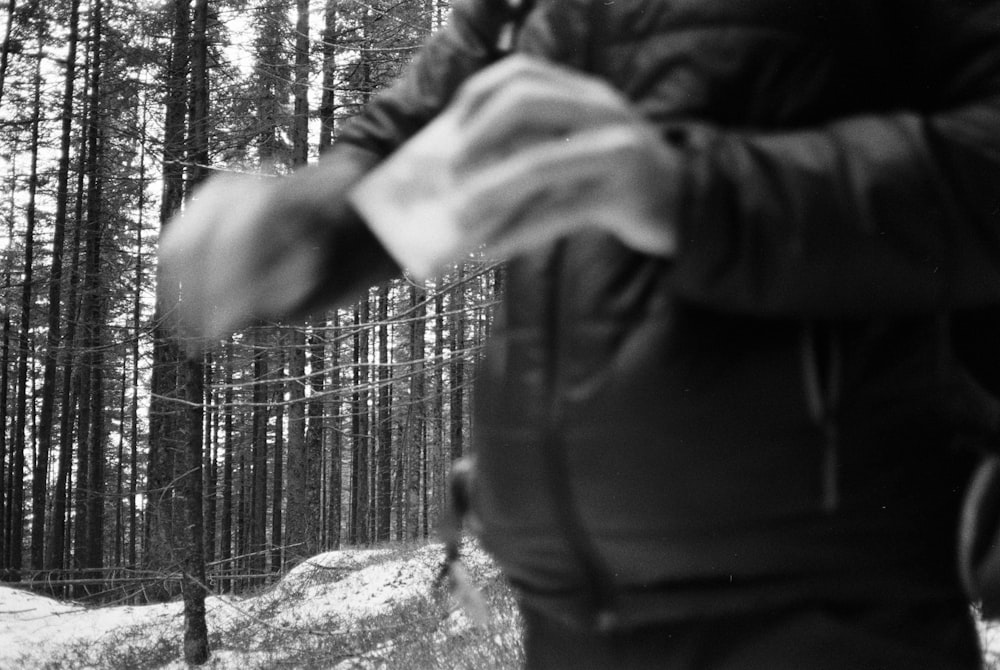 a black and white photo of a person in the woods
