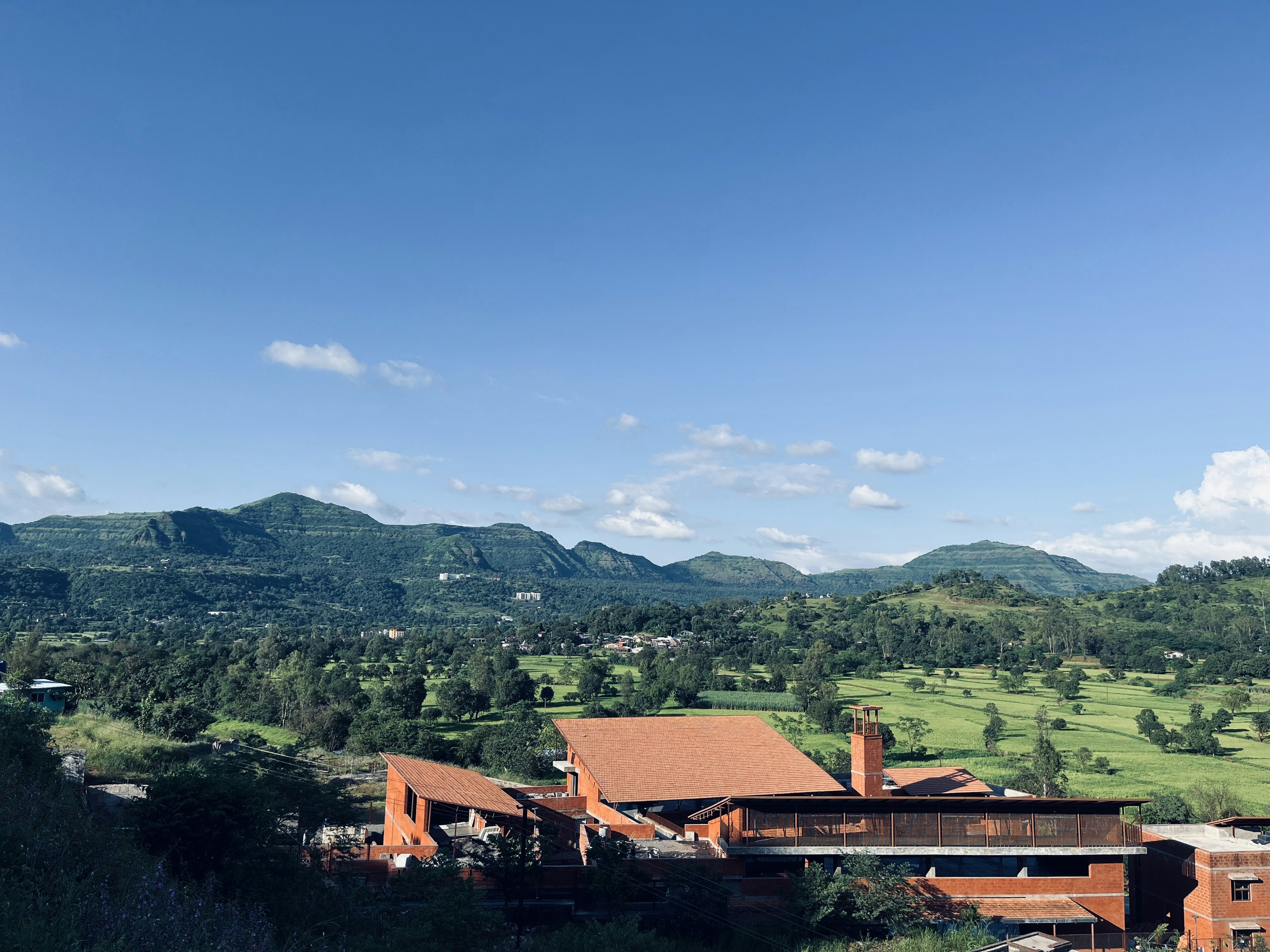 a view of a large building in the middle of a field