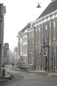 A serene cobblestone street bathed in soft morning light, framed by historic European architecture.