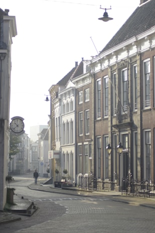 A quiet cobblestone street in a European village bathed in soft morning light.