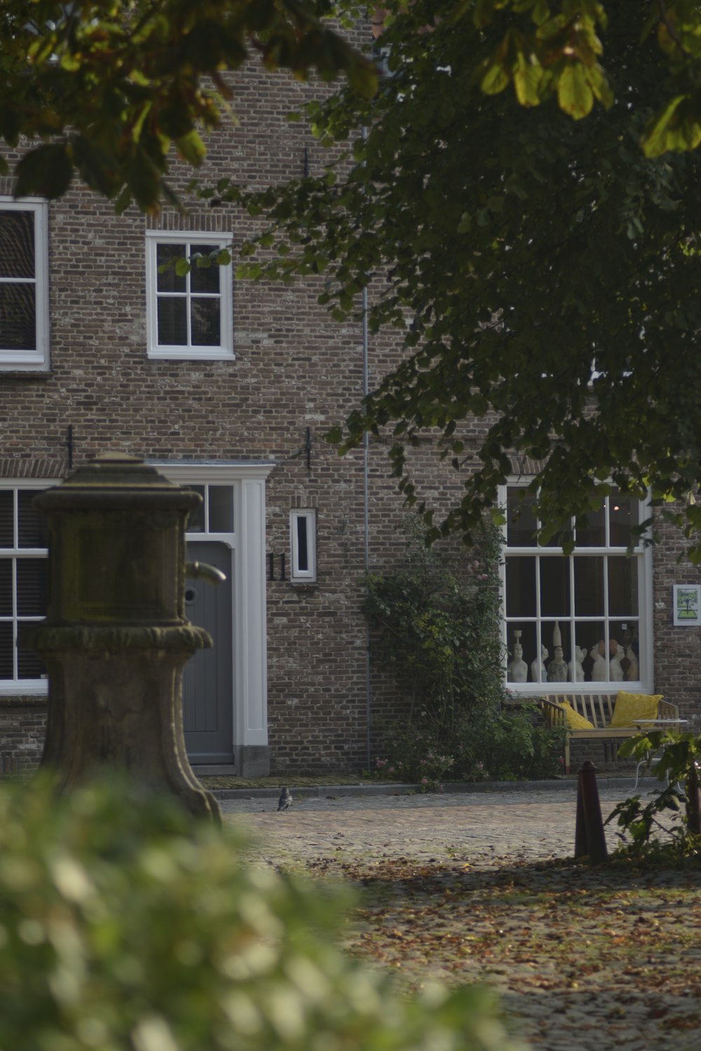 a brick building with a fountain in front of it