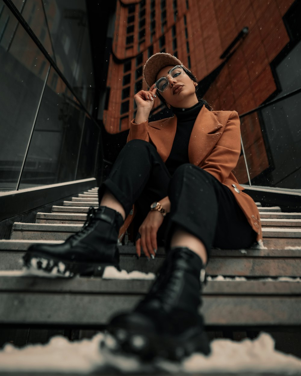 a woman sitting on steps talking on a cell phone