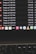 A computer screen displays a list of files with details such as timestamps, file sizes, and formats in a dark-themed interface. The bottom part of the screen shows various application icons on a MacOS dock, including familiar apps like VLC, WhatsApp, and Apple Music. A keyboard is partially visible at the bottom.